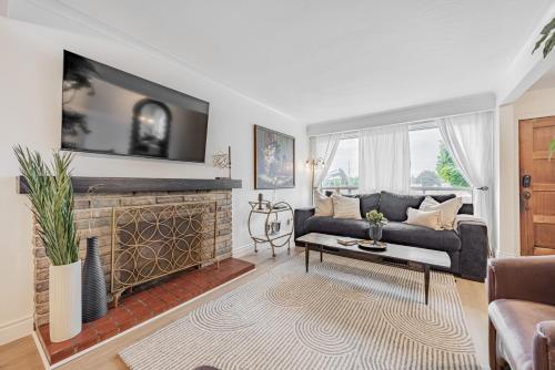 a living room with a couch and a fireplace at Unique Oasis with Tri-City Access in Mississauga
