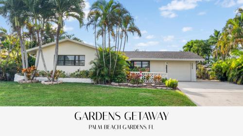 a house with palm trees in front of it at Family Retreat near Beach, Downtown and PGA in Palm Beach Gardens