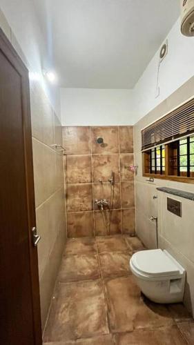 a bathroom with a toilet and a shower at Traditional house near Kochi in Cochin