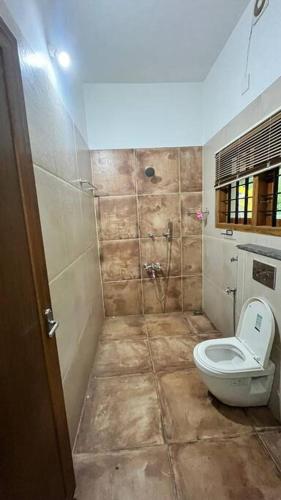 a bathroom with a toilet and a shower at Traditional house near Kochi in Cochin