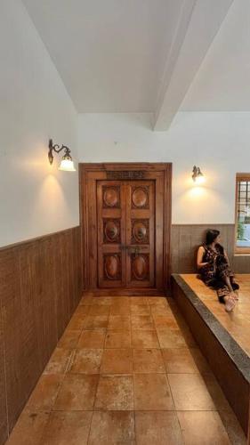 a person sitting on a bench in a room at Traditional house near Kochi in Cochin