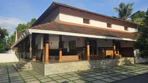 a house with a courtyard in front of it at Traditional house near Kochi in Cochin