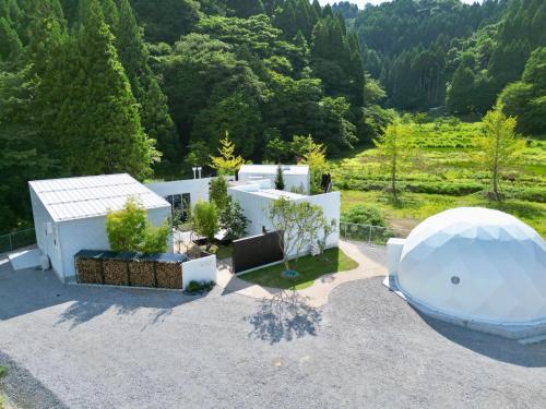 an exterior view of a white house with a dome at LOCA THE JUNPU Moroyose in Moroyose