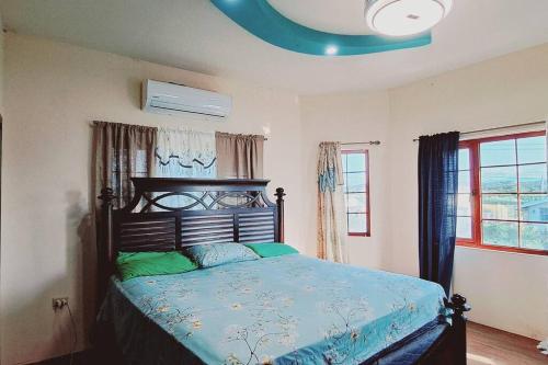 a bedroom with a bed with green pillows on it at Samuel's Place - Central, Modern, 3 Br, 3Ba, Gated in Cacandee Settlement
