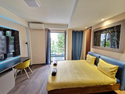 a room with a bed and a couch and a television at Vanilla Boutique Apartments in Skopje
