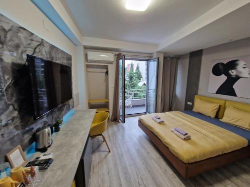 a hotel room with a bed and a television at Vanilla Boutique Hotel in Skopje