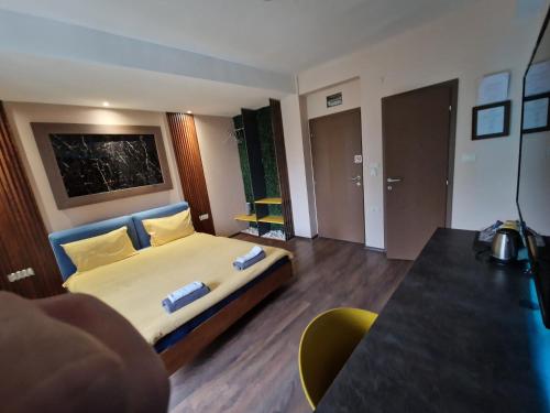 a hotel room with a bed and a table at Vanilla Boutique Hotel in Skopje
