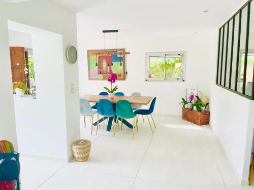 une salle à manger avec une table et des chaises dans l'établissement Villa les cèdres piscine nature, à Fabrègues