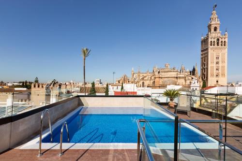 a swimming pool on the roof of a building at Hotel Casa 1800 Sevilla in Seville