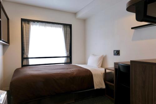 Postel nebo postele na pokoji v ubytování Belmont Hotel