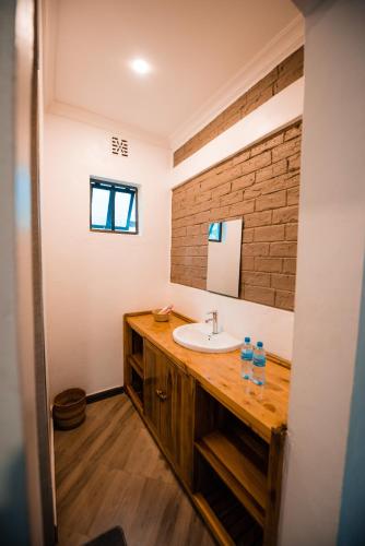 a bathroom with a sink and a mirror at Katiti Lodge in Arusha