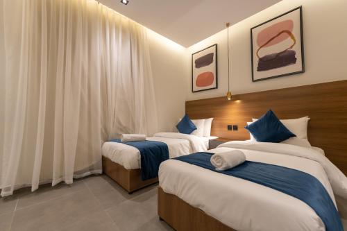 a hotel room with two beds in it at ارجان بارك الشفا in Riyadh