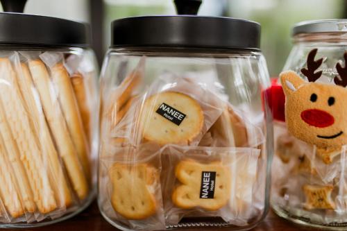 a group of glass jars filled with food at NANEE Phra Singh in Chiang Mai