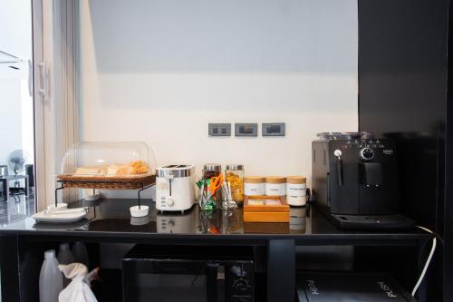 a kitchen with a counter top with some food on it at NANEE Phra Singh in Chiang Mai