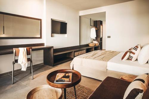 a hotel room with a bed and a couch at Cook's Club Ialysos Rhodes in Ialyssos
