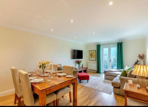 a dining room with a table and a living room at Inglewood Apartment, Ingleton, Yorkshire Dales National Park, Famous Three Peaks, Near The Lake District, Pets Are Welcome in Ingleton