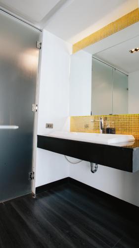 a bathroom with a sink and a mirror at NANEE Phra Singh in Chiang Mai