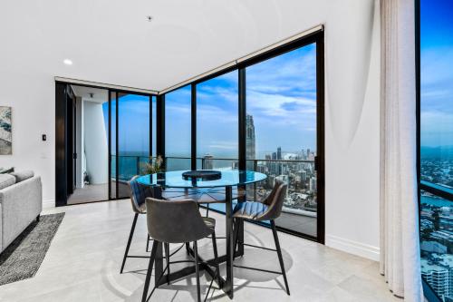 a dining room with a glass table and chairs at Circle on Cavill - Self Contained & Privately Managed - Wow Stay in Gold Coast