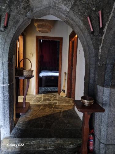 a hallway with an archway in a building with a bedroom at Ballindooley Castle in Galway