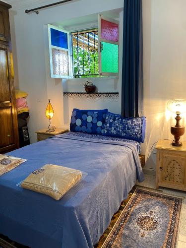 a bedroom with a blue bed and a window at Villa Dar Lghzal Summer Promo Airport Pick-Up & Private Dining in Heart of Rabat in Rabat