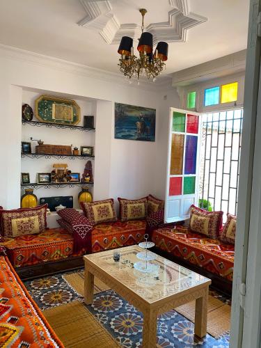 a living room with couches and a coffee table at Villa Dar Lghzal Summer Promo Airport Pick-Up & Private Dining in Heart of Rabat in Rabat