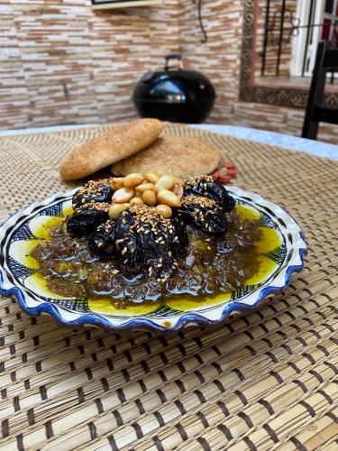 a plate of food on top of a table at Villa Dar Lghzal Summer Promo Airport Pick-Up & Private Dining in Heart of Rabat in Rabat