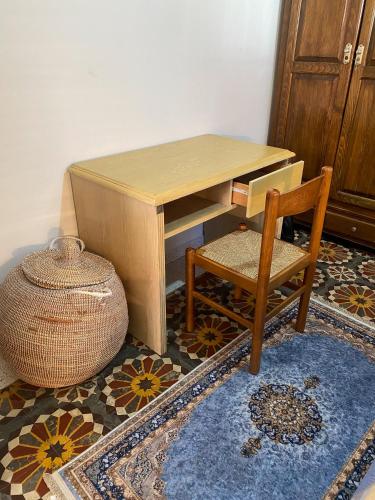 a wooden desk with a chair and a table with a vase at Villa Dar Lghzal Summer Promo Airport Pick-Up & Private Dining in Heart of Rabat in Rabat