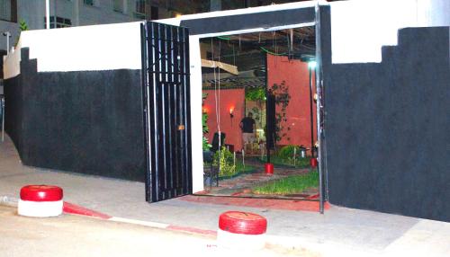 a black gate with red barriers in front of a building at Villa Dar Lghzal Summer Promo Airport Pick-Up & Private Dining in Heart of Rabat in Rabat