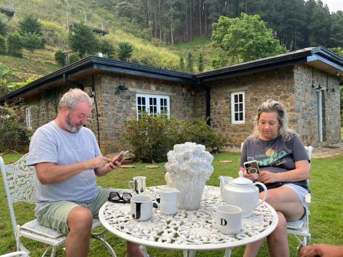 a man and a woman sitting at a table at 4154ft in ramboda in Ramboda