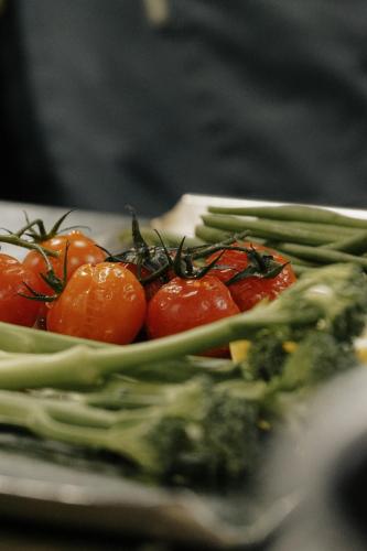 a plate of vegetables with tomatoes and green beans at Vimmerby Stadshotell, WorldHotels Crafted in Vimmerby