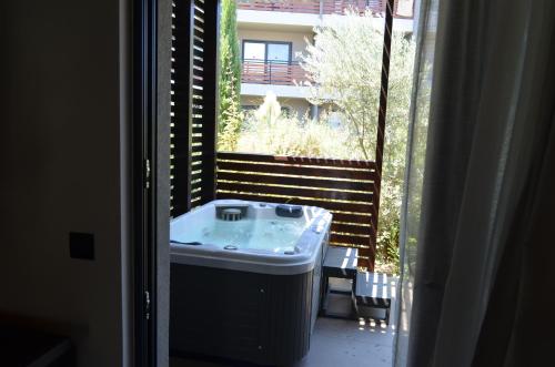 a bathroom with a sink and a large window at Cook's Club Ialysos Rhodes in Ialyssos