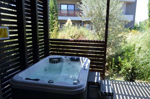 a jacuzzi tub sitting on top of a patio at Cook's Club Ialysos Rhodes in Ialyssos