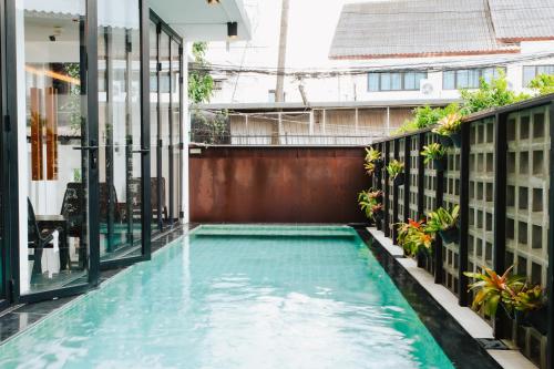an infinity pool in the middle of a building at NANEE Phra Singh in Chiang Mai