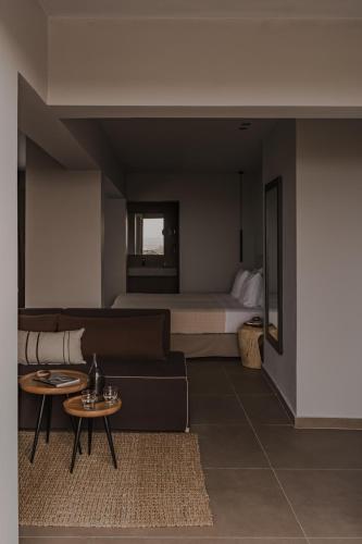 a living room with a couch and a bed at Cook's Club Ialysos Rhodes in Ialyssos