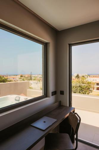 a desk in a room with a large window at Cook's Club Ialysos Rhodes in Ialyssos