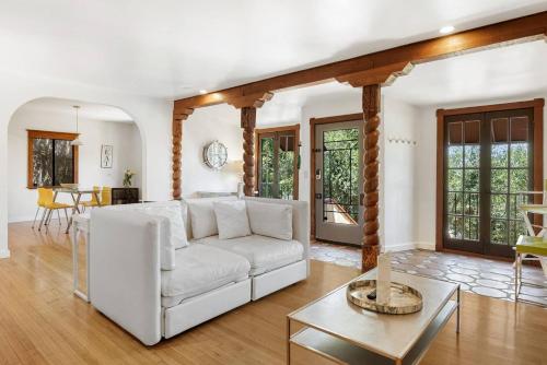 a living room with a white couch and a table at Hollywood Hills Walk to Universal City Views in Los Angeles