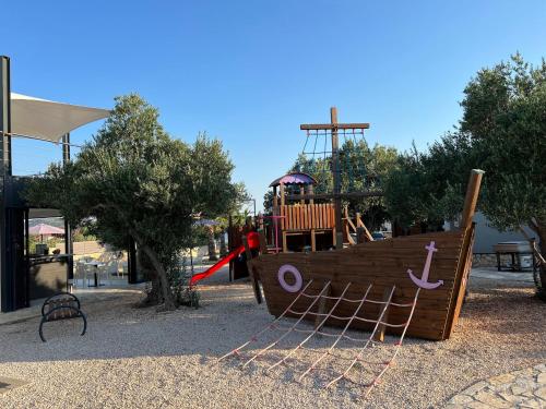 a playground with a pirate ship and a slide at Vi&No Mobile Home - Camping Pirovac in Pirovac