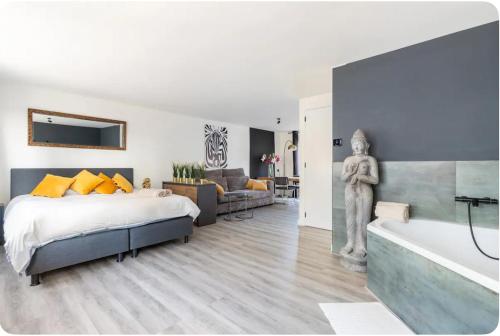 a bedroom with a large bed and a bath tub at Studio Romantic in Zandvoort