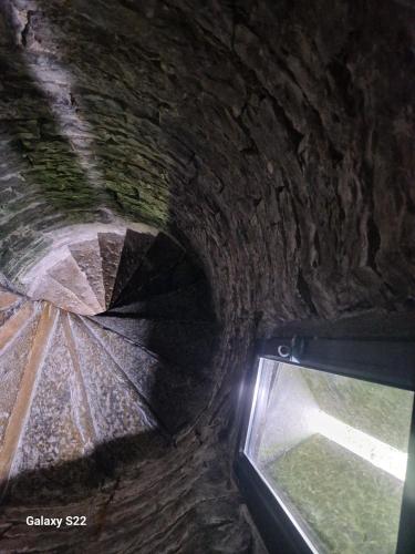 an old stone tunnel with a window and an umbrella at Ballindooley Castle in Galway