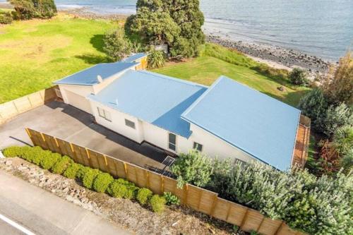 an overhead view of a house with a blue roof at The Bach Wai Rua A Waterfront Home in Opononi