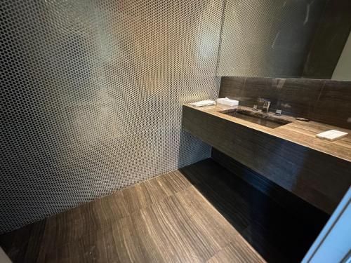 a bathroom with a sink and a shower at DAMAC Towers Riyadh by SELSAL داماك الرياض in Riyadh