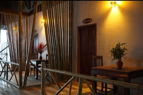 a dining room with a table and chairs and a room with a tableablish at Villa Sala Vanna in Savannakhet