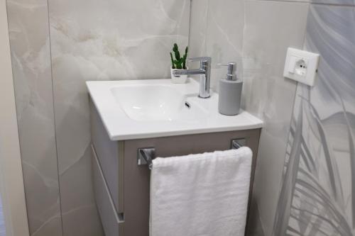 a bathroom with a sink and a white towel at Bed and Breakfast 3 Medaglie in Rende
