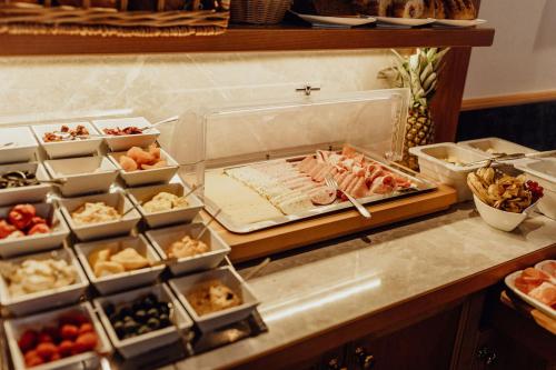 a buffet with different types of food on a counter at Dorfcafe Unken Hotelpension sWirtshaus im Dorf in Unken