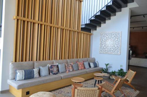 a living room with a couch and some chairs at Cook's Club Ialysos Rhodes in Ialyssos
