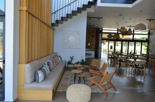 a living room with a couch and chairs and tables at Cook's Club Ialysos Rhodes in Ialyssos