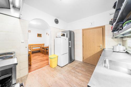 a kitchen with a refrigerator and a table at Ubytování u Foltýnů - Zelená Lhota in Nýrsko