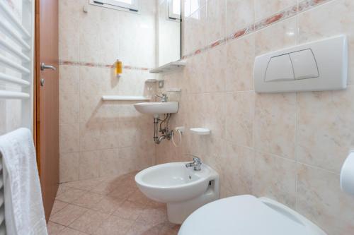 a bathroom with a toilet and a sink at Residence Rimini Relax in Rimini
