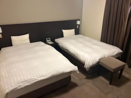 Katil atau katil-katil dalam bilik di Dormy Inn Express Koriyama