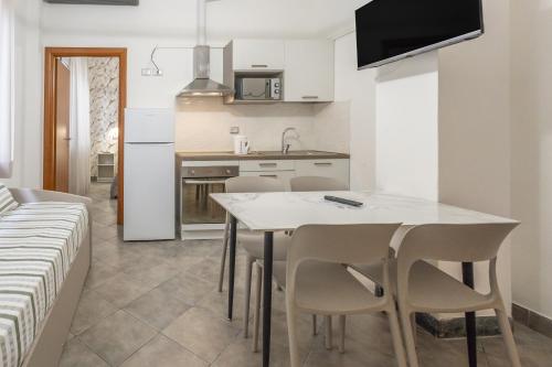 a kitchen and dining room with a table and chairs at Residence Rimini Relax in Rimini